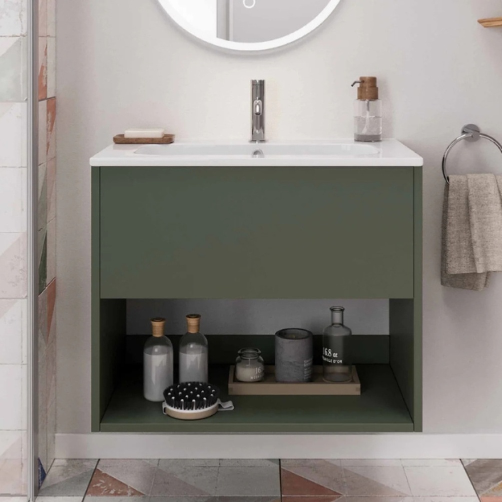 Lifestyle image of the Britton Hackney Earthy Green 600mm Wall Hung Vanity Unit & Basin installed on a beige bathroom wall with basin mixer tap and shelf in use